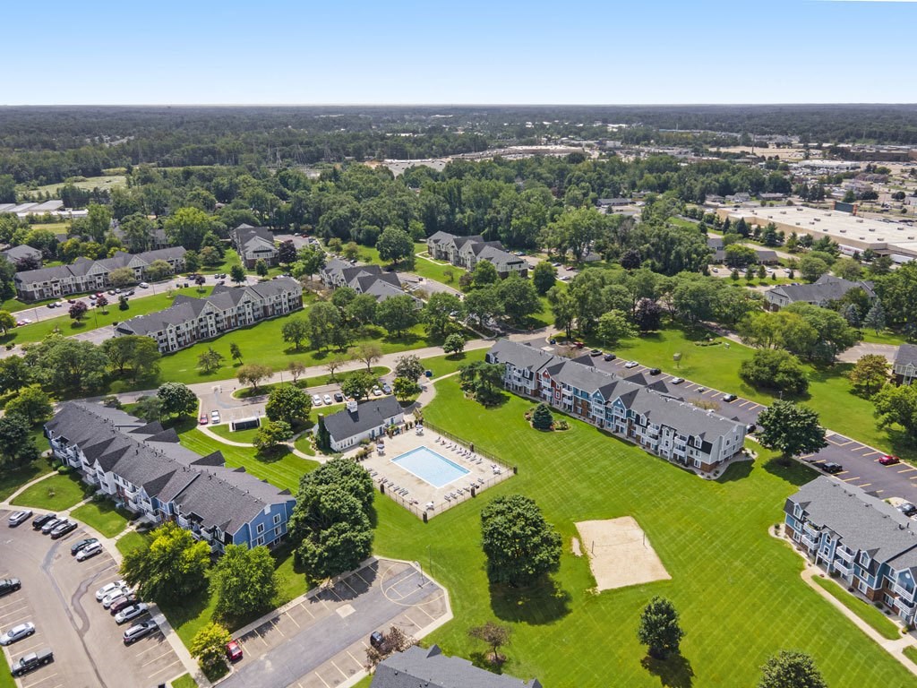 an aerial view of a pool with sundeck at Newport Village Apartments, Portage, MI
