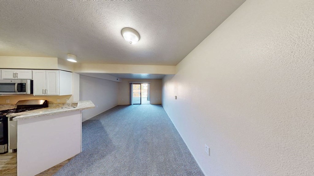 a renovated kitchen and a large living room at North Pointe Apartments in Elkhart, IN