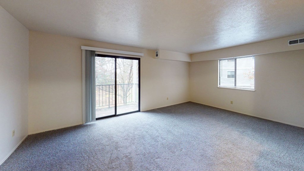 enlarged living room with a sliding glass door to a balcony at North Pointe Apartments, Indiana, 46514