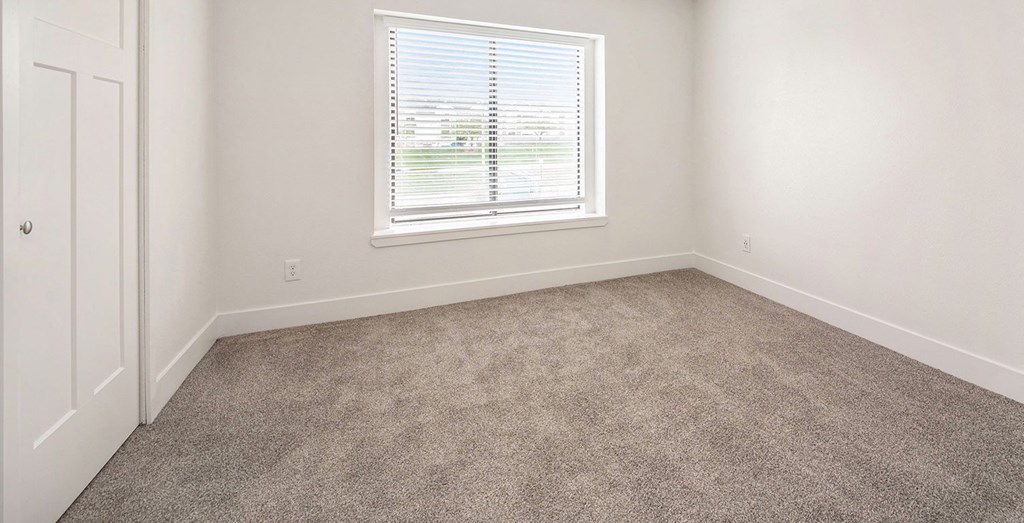 Bedroom with carpet and a window at North Pointe Apartments in Elkhart, IN