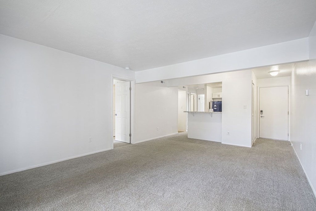 living room and kitchen with carpeting at North Pointe Apartments in Elkhart, IN