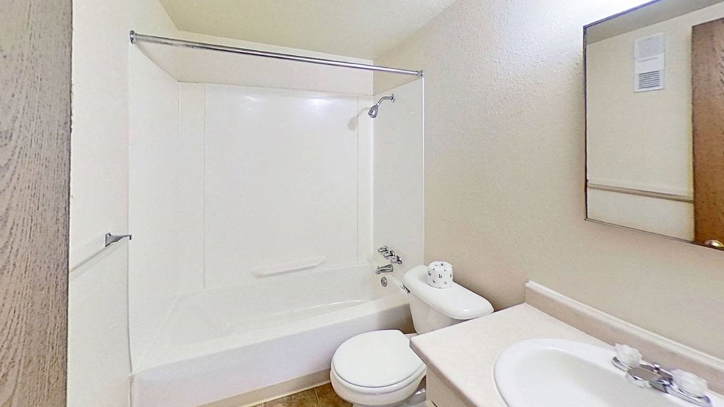 master bathroom with a sink toilet and a bathtub/shower combination at Normandy Village Apartments, Michigan City, 46360