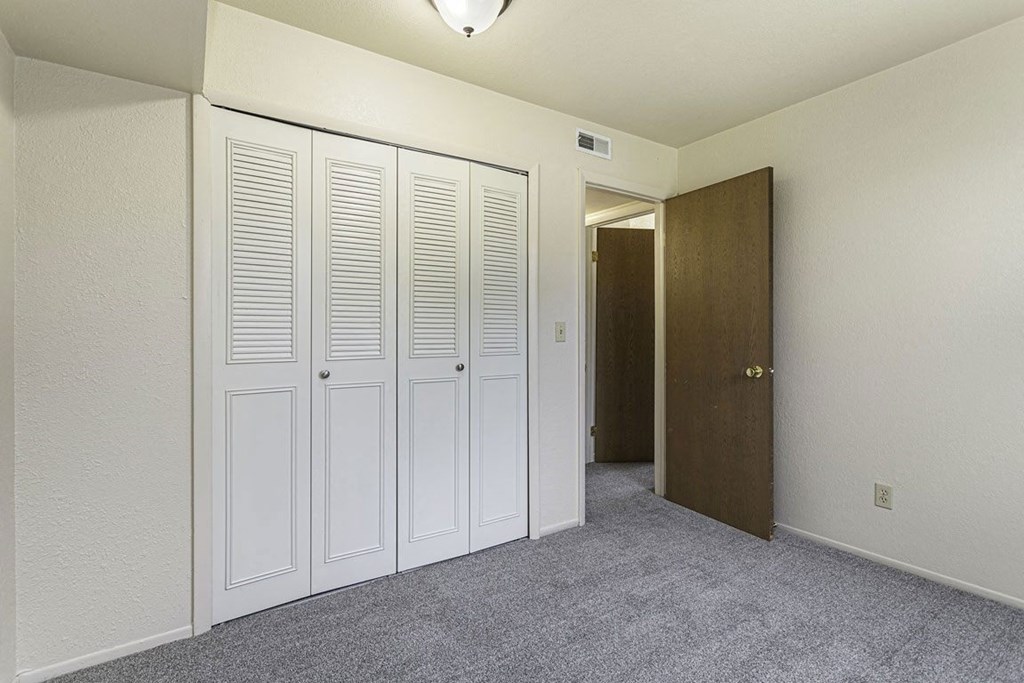 a bedroom with a large closet at Normandy Village Apartments, Indiana