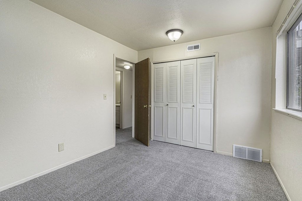 Bedroom with a large window and closet at Normandy Village Apartments, Indiana, 46360