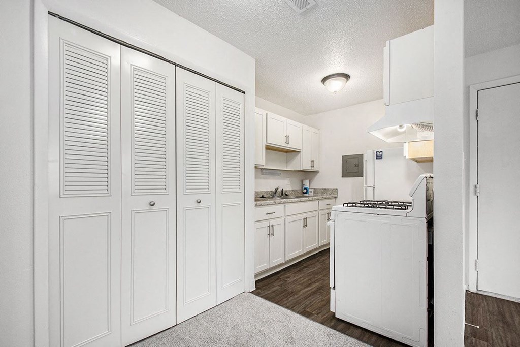a renovated kitchen with white cabinets and a stove and a sink at Normandy Village Apartments, Indiana, 46360