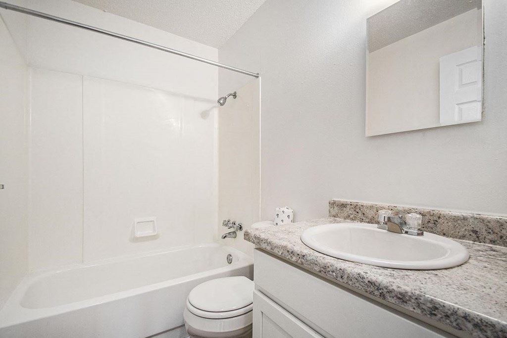 a bathroom with a sink toilet and a bath tub at Normandy Village Apartments, Indiana