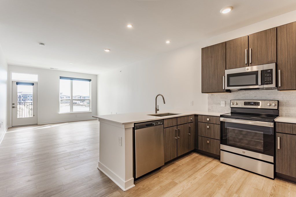 A kitchen with wooden cabinets and stainless steel appliances