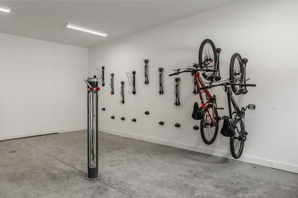 a wall with bikes hanging on it and other bike parts on the wall at Nuvo Flats, Merrillville, IN, Indiana