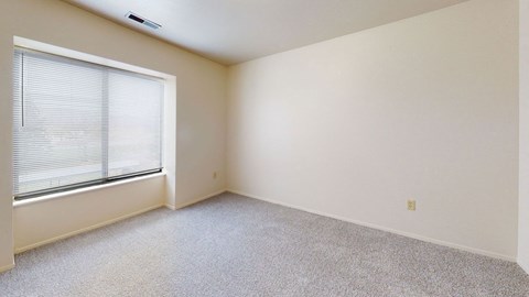 Spacious bedroom with a large window at Oak Shores Apartments, Oak Creek, Wisconsin