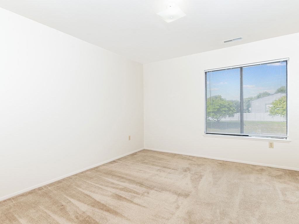 Bedroom with Large Window at Oak Shores Apartments in Oak Creek, WI