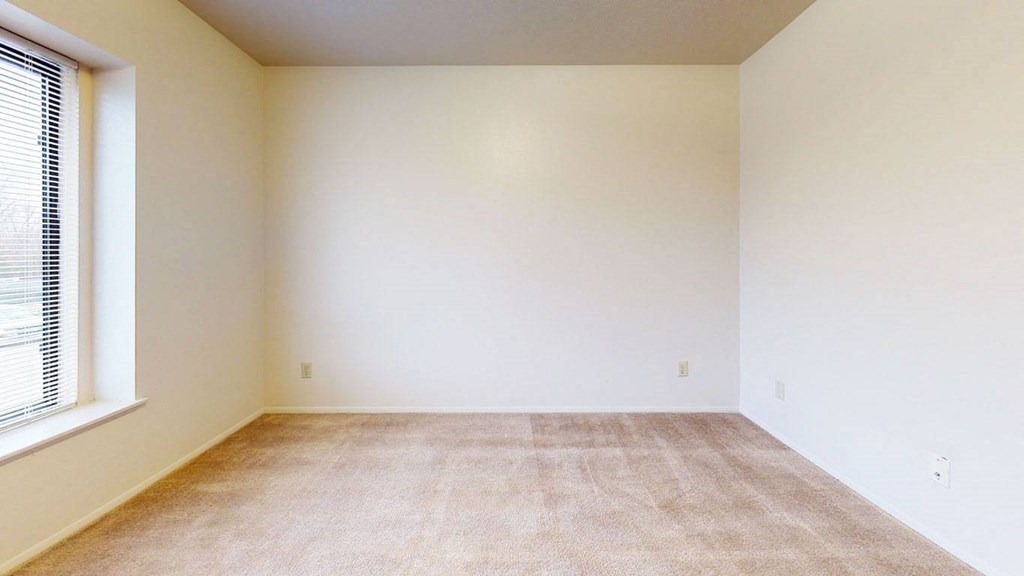 bedroom with a large window and plush carpeting at Pine Knoll Apartments, Battle Creek, 49014