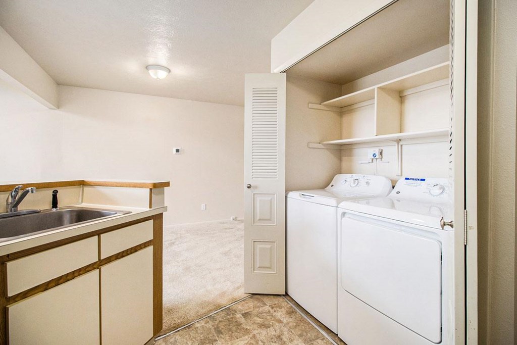 kitchen a kitchen with a washer and dryer at Pine Knoll Apartments, Battle Creek, MI