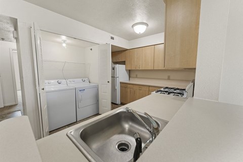 a kitchen with white appliances and a sink