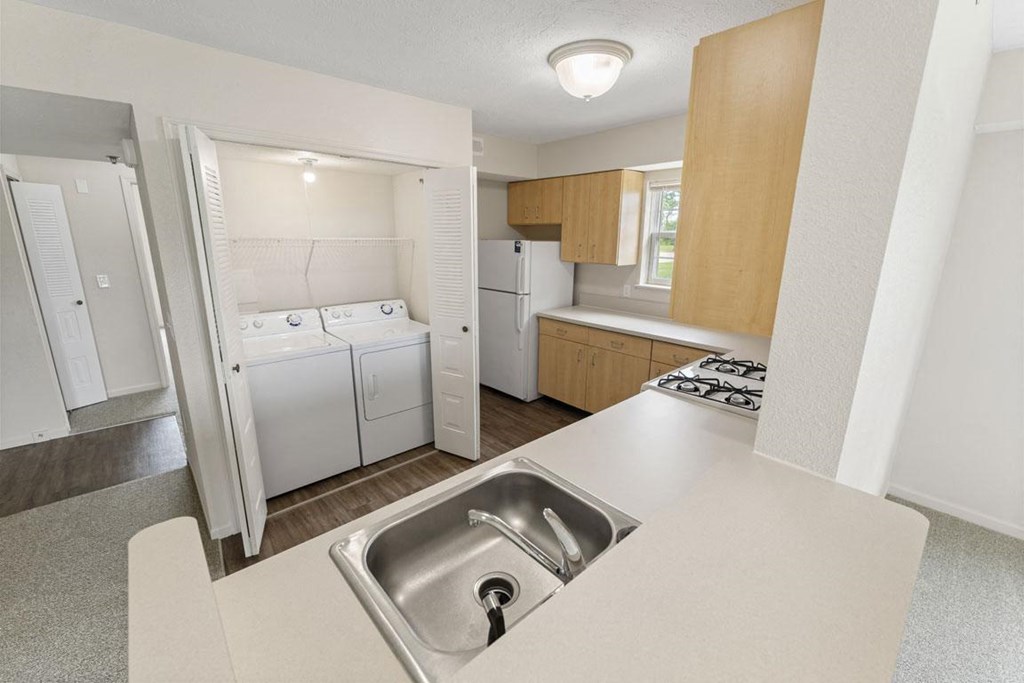 a kitchen with a washer and dryer and a window at Hunters Pond Apartment Homes, Champaign, IL