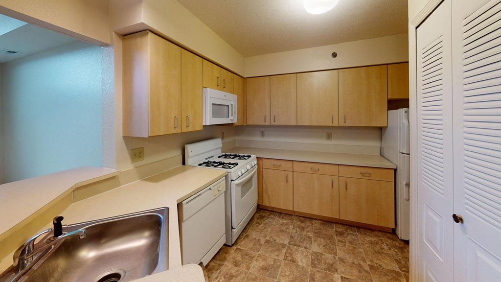 Large kitchen with white appliances at Hunters Pond Apartment Homes in Champaign, Illinois