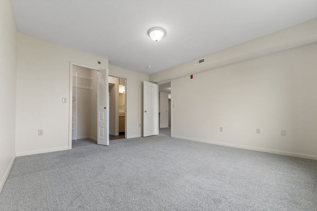 primary bedroom with walk in closet and bathroom with walk in shower at Hunters Pond Apartment Homes, Champaign, Illinois
