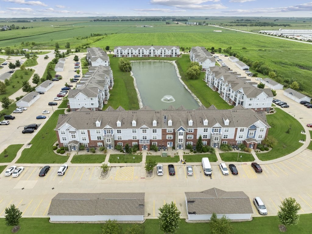 an aerial view of an apartment community with a pond at Hunters Pond Apartment Homes, Champaign, 61820