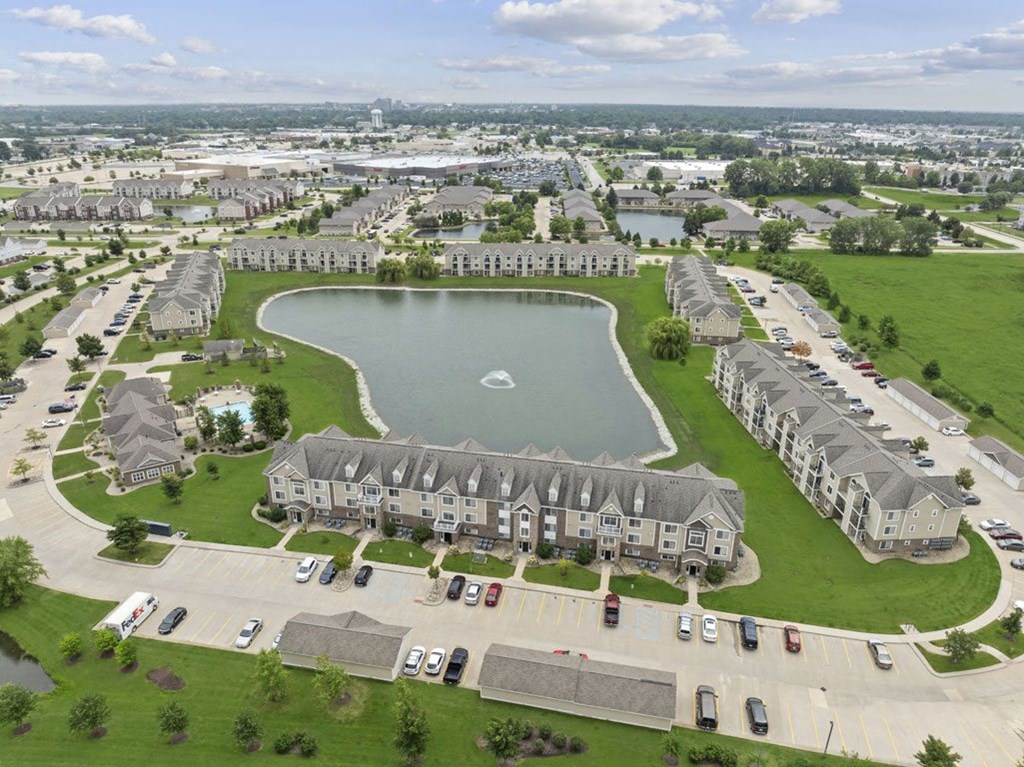 drone view of scenic community with pond fountains at Hunters Pond Apartment Homes, Champaign, 61820