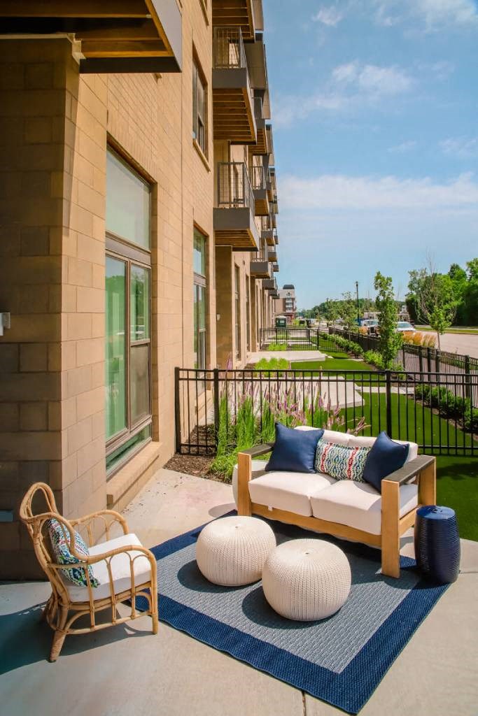 a couch sitting on top of a rug in front of a building  at Avant & Avant II, Carmel, Indiana
