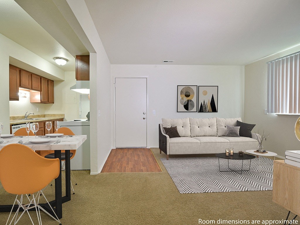 Living Room With Kitchen View at Perry Place Apartments, Grand Blanc, MI