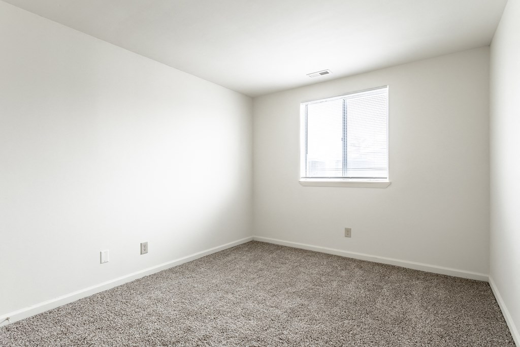 an empty room with carpet and a window at Pheasant Run Apartments, Lafayette, 47909
