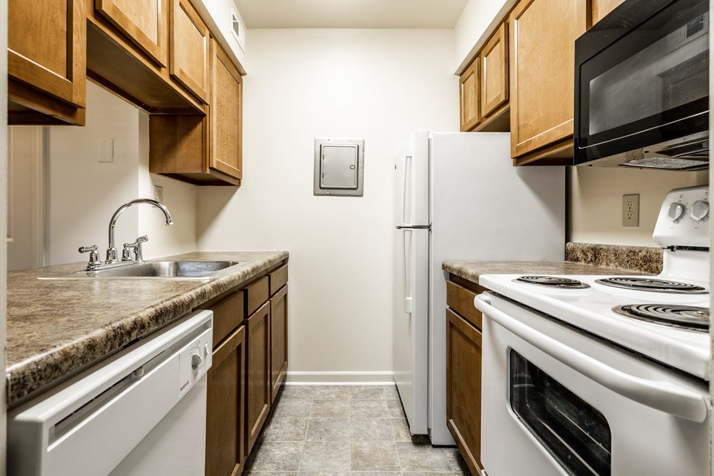a kitchen with white appliances at Pheasant Run Apartments, Indiana