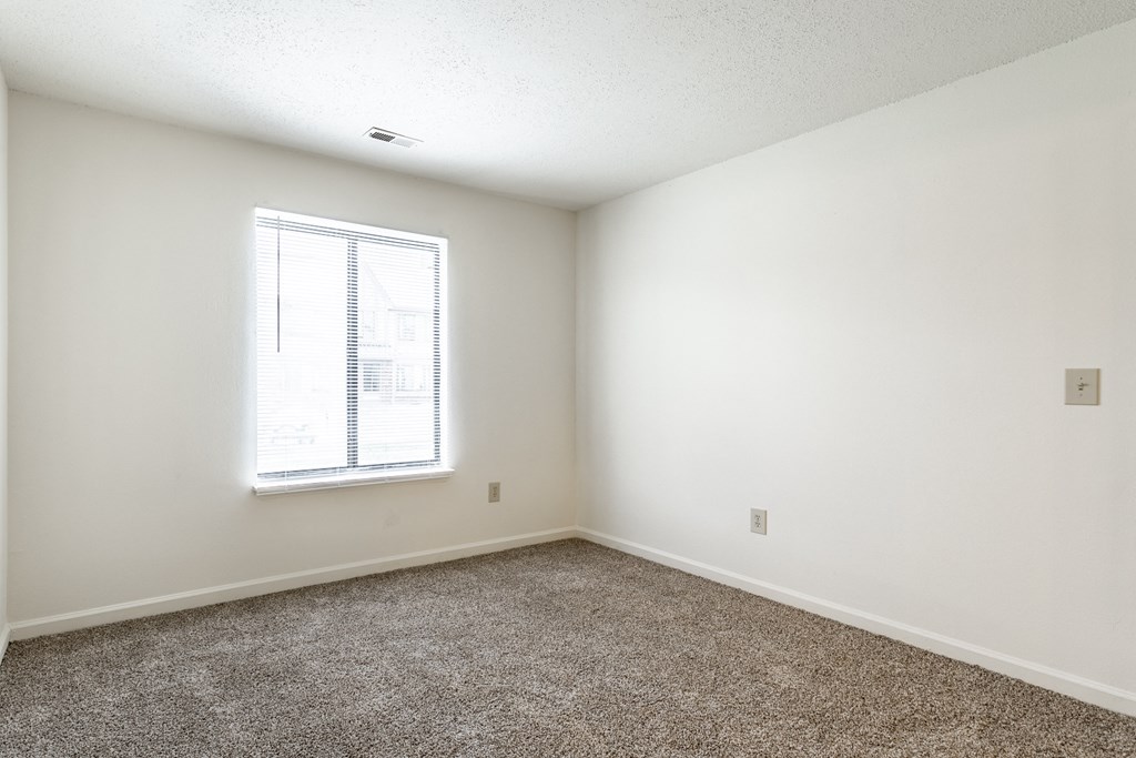 an empty room with carpet at Pheasant Run Apartments, Indiana