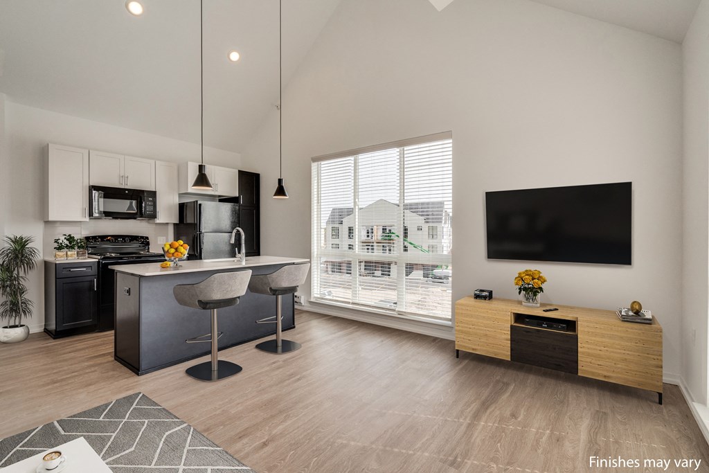 a kitchen and living room with a large window and a view of a house  at Uptown Square Apartments, Troy, MI, 48083