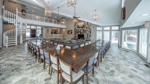 A large dining room with a long table and chairs at Portsmouth Apartments, 48377
