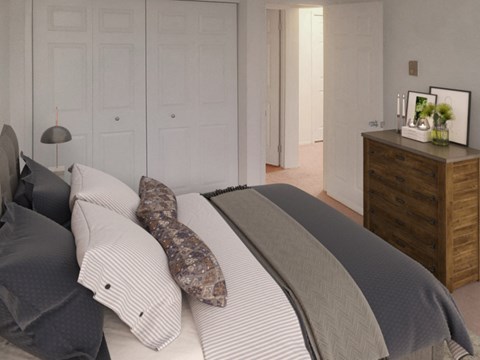 a bedroom with a bed and a dresser