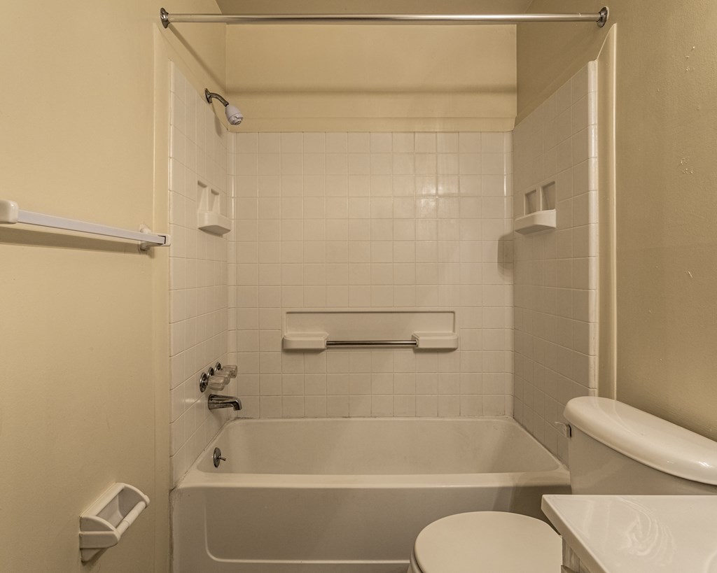 a bathroom with a tub and a toilet and a sink at Scarborough Lake Apartments, Indiana, 46254