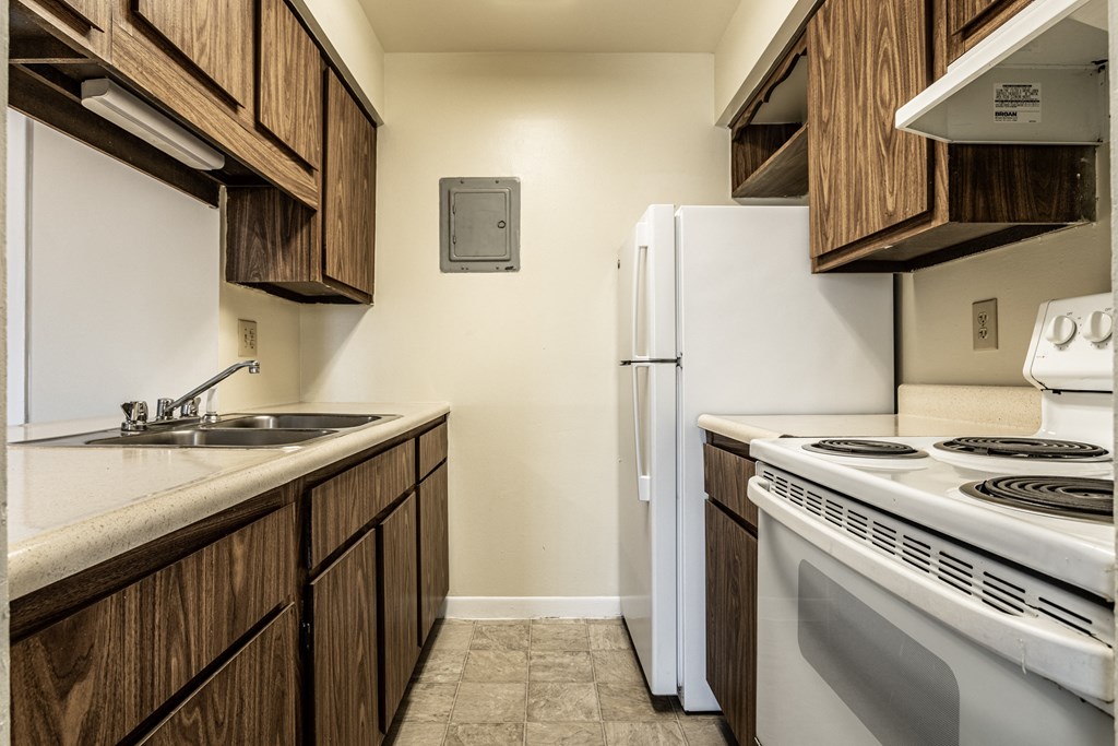 a kitchen with white appliances and wooden cabinets and a white refrigerator at Scarborough Lake Apartments, Indianapolis, IN, 46254