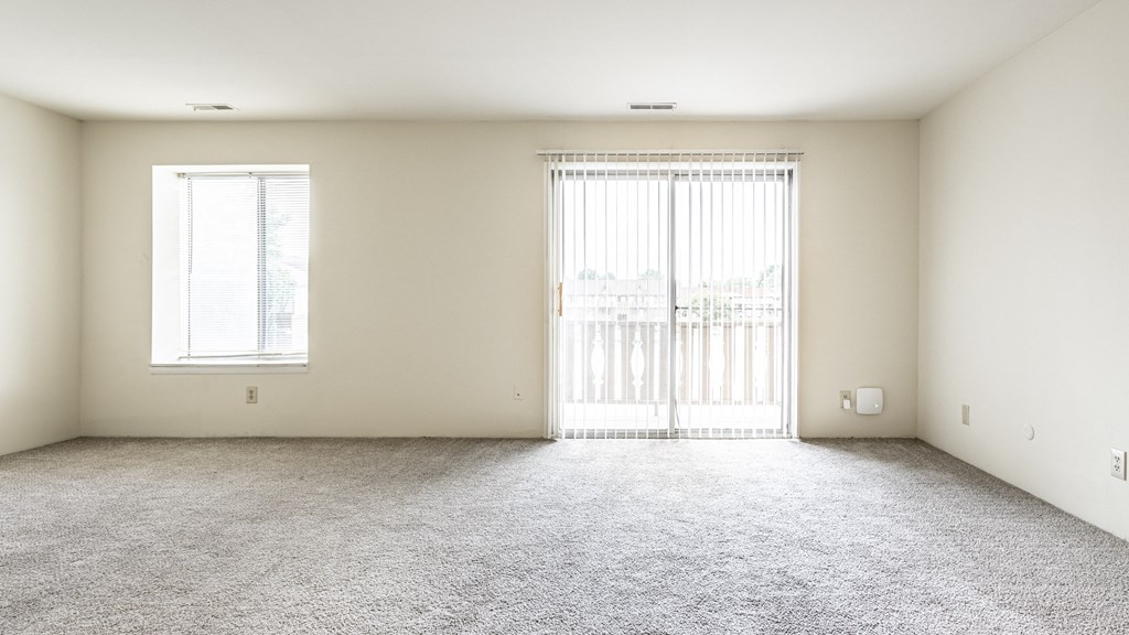 an empty living room with a window and a carpeted floor at Scarborough Lake Apartments, Indiana, 46254