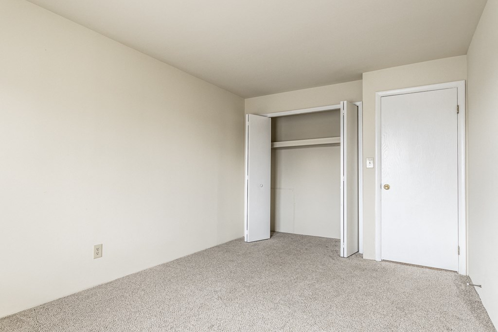 a bedroom with a closet and an open door at Scarborough Lake Apartments, Indianapolis, IN, 46254