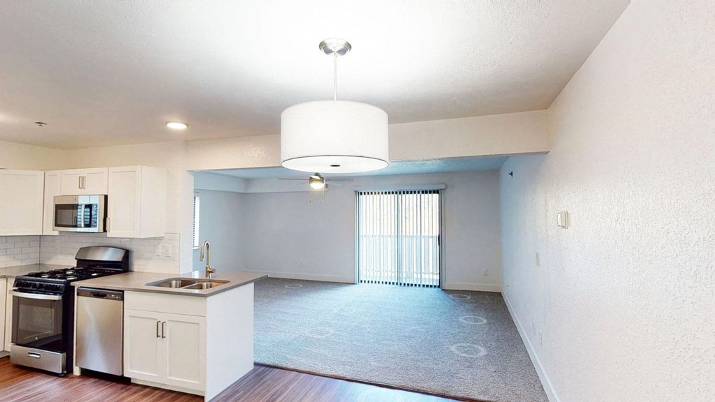 a kitchen with a stove top oven and a sink at Green Ridge Apartments, Grand Rapids, MI