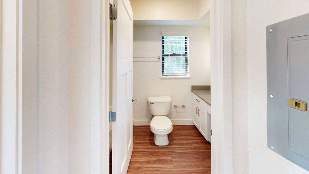 a bathroom with a toilet and a window at Green Ridge Apartments, Grand Rapids, 49544