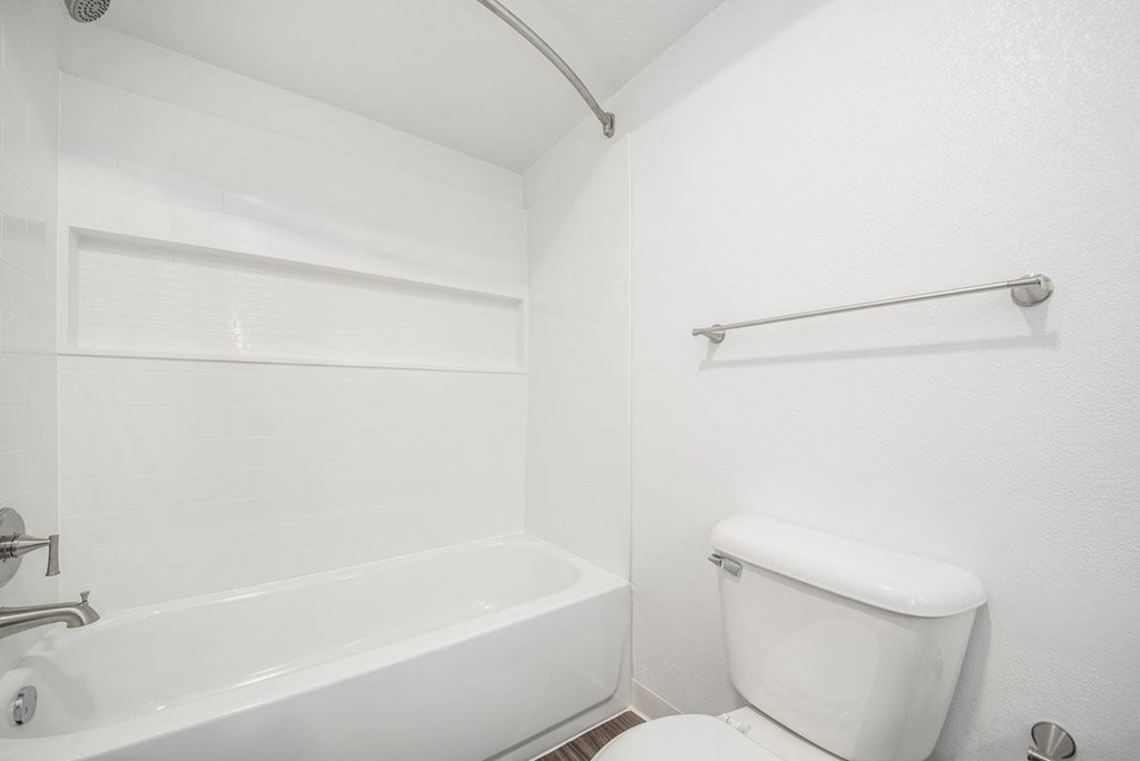 a bathroom with a toilet and a bathtub at Green Ridge Apartments, Grand Rapids, Michigan