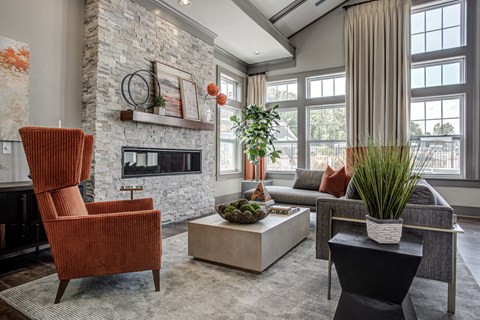 A living room with a fireplace and a chair. at River Crossing Apartments, St. Charles, 63303