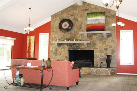 a living room with a couch and a stone fireplace