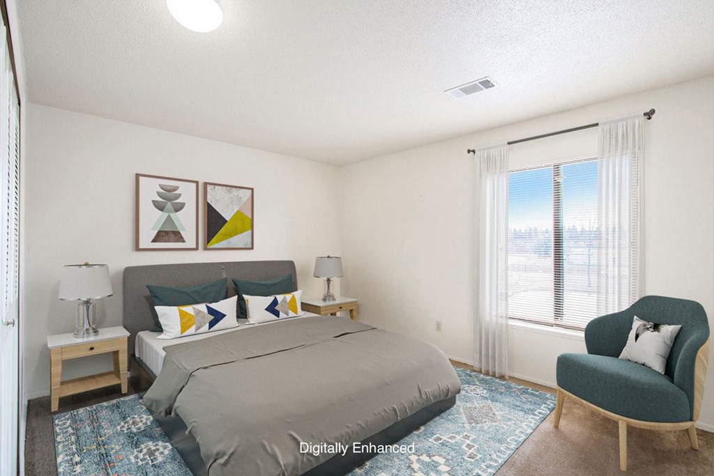 a bedroom with a large window a bedroom with a large window at Seville Apartments, Kalamazoo, MI, 49009