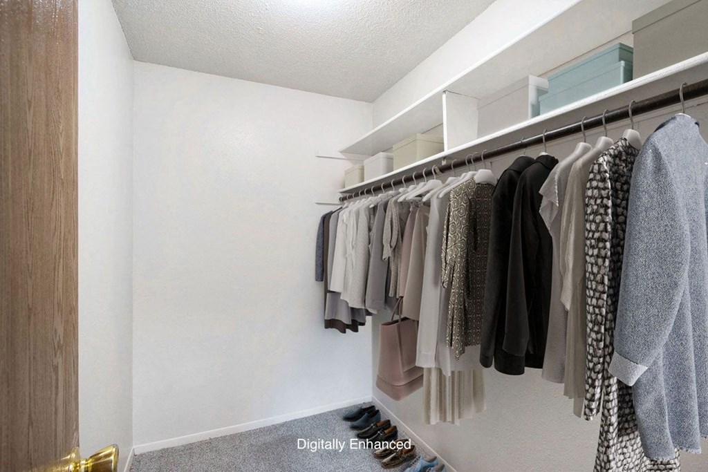 a walk in closet with a rack of clothes at Seville Apartments, Kalamazoo, MI, 49009