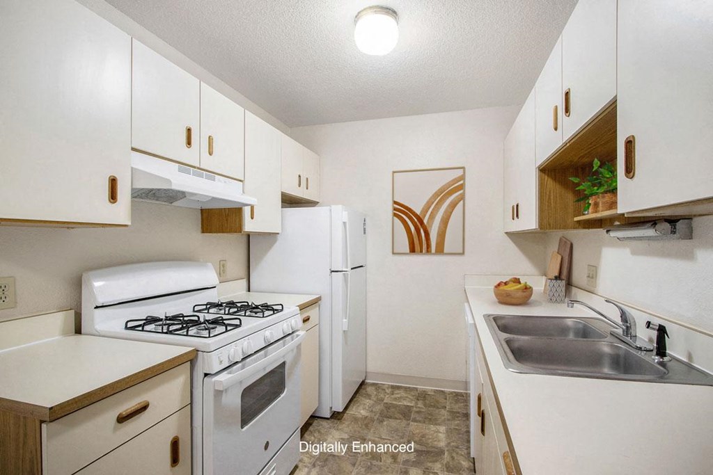 a kitchen with a gas stove a kitchen with a gas stove at Seville Apartments, Kalamazoo, MI, 49009