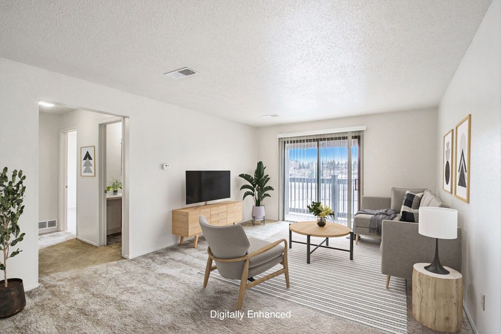 a living room with a couch and a slider to a balcony at Seville Apartments, Kalamazoo, MI, 49009