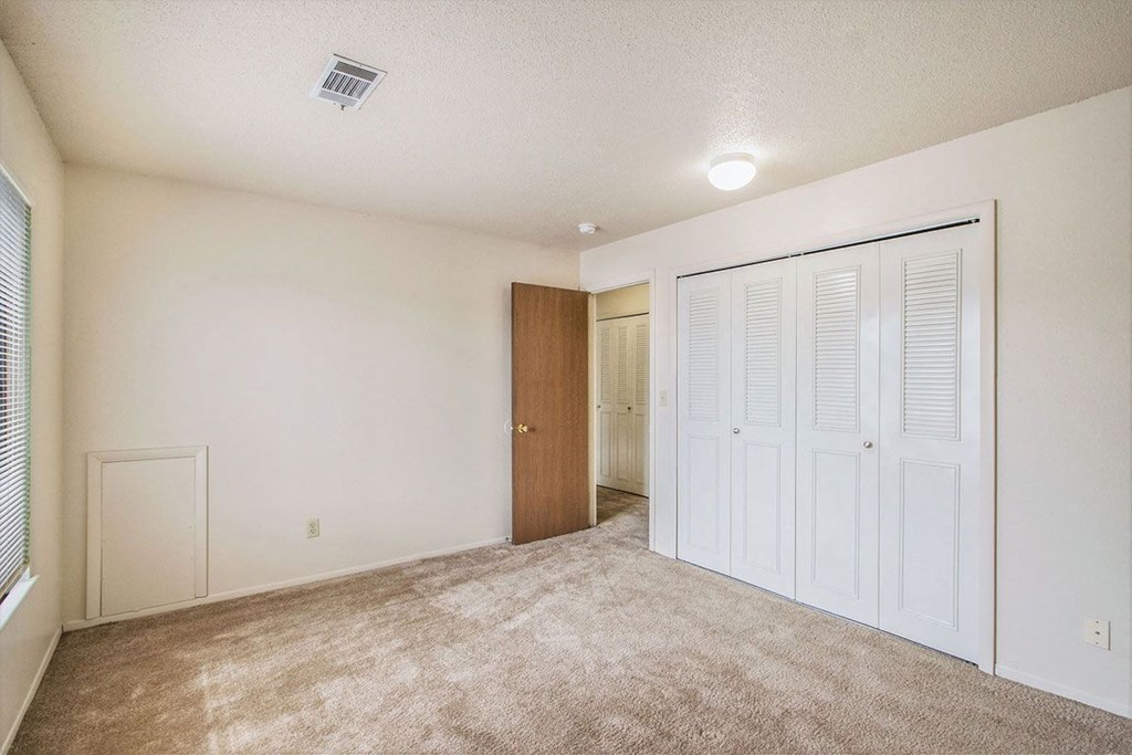 Bedroom with large closet at Seville Apartments, Kalamazoo, Michigan