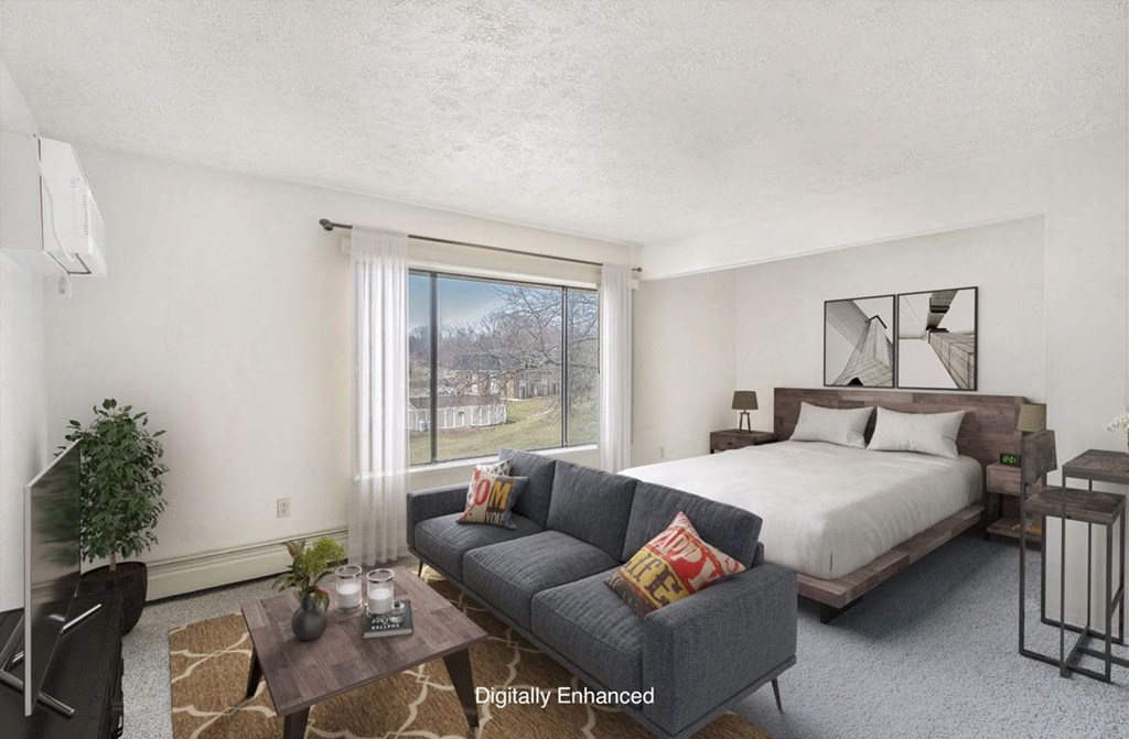 studio living areas with large window at Seville Apartments in Kalamazoo, MI 49009