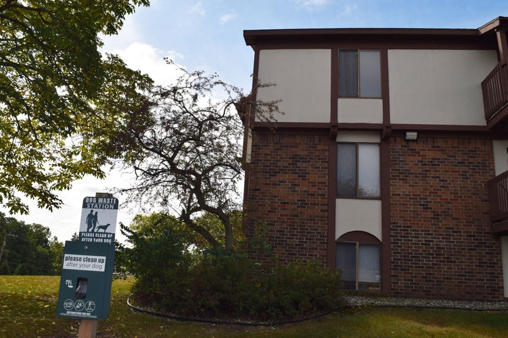 pet waste station outside apartment buildingat Seville Apartments, Michigan