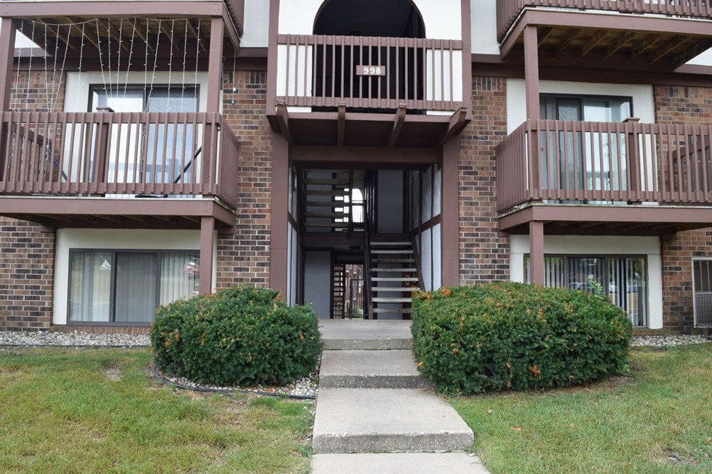 the walkway up to the entrance of a brick apartment building at Seville Apartments, Michigan