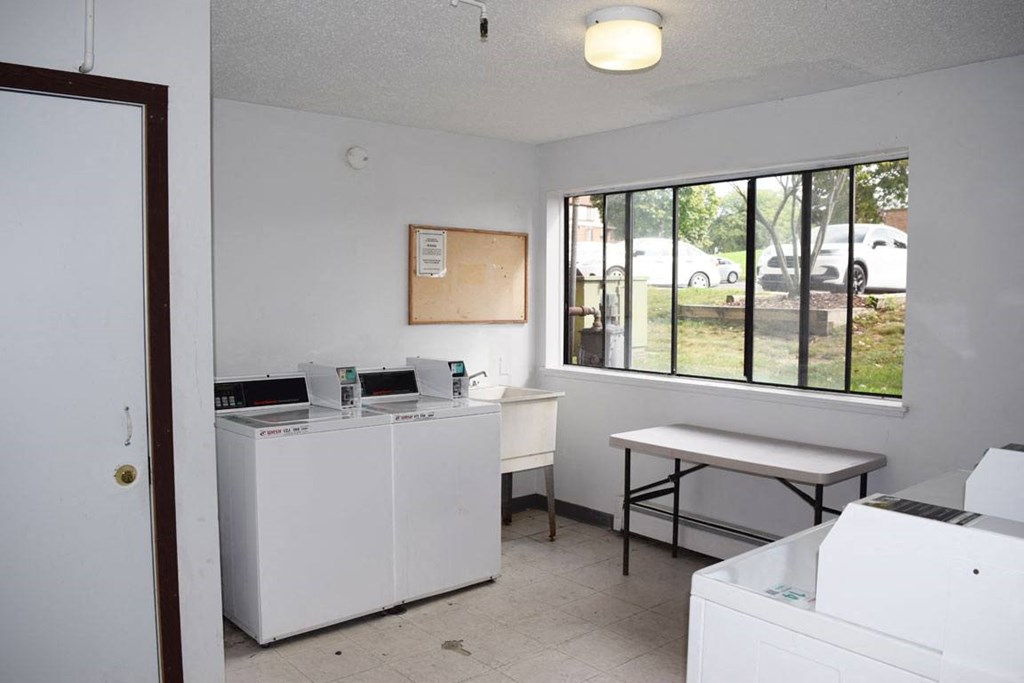 laundry room with a sink and a large window at Seville Apartments, Michigan