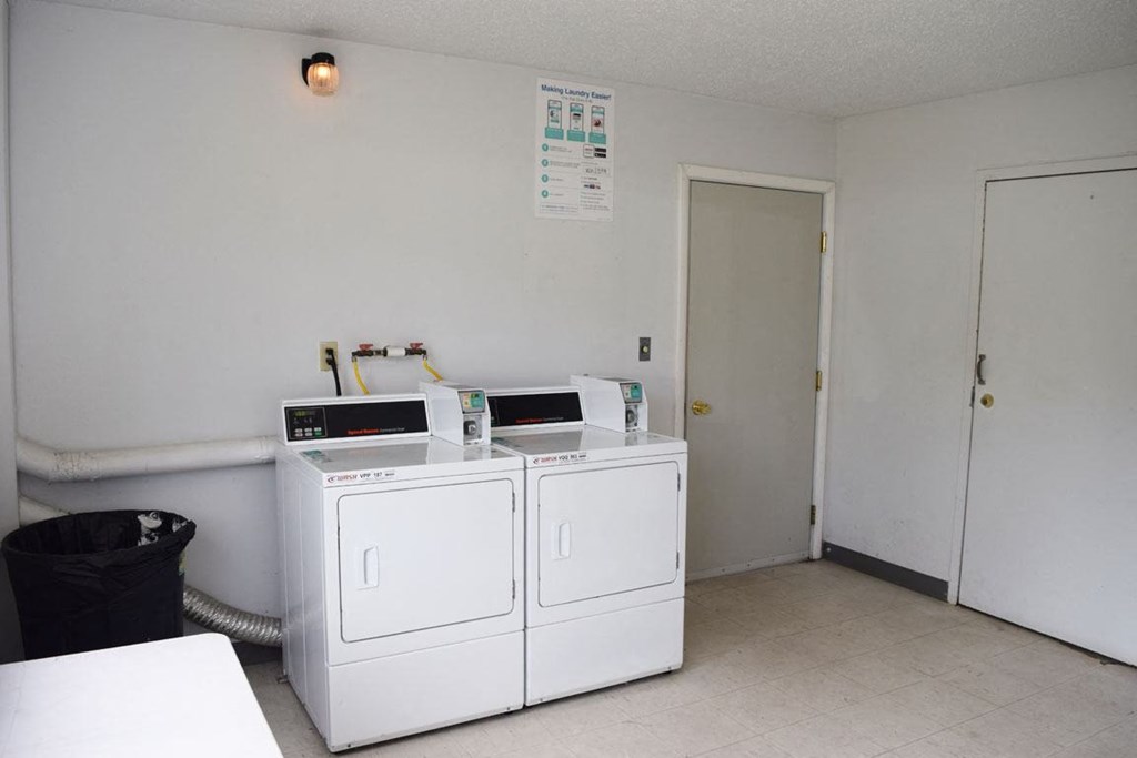 a laundry room with two washing machines at Seville Apartments, Michigan