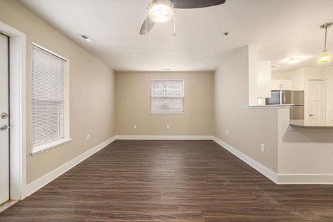End style living room with wood flooring and an extra window  at Signature Pointe Apartment Homes, Athens, AL